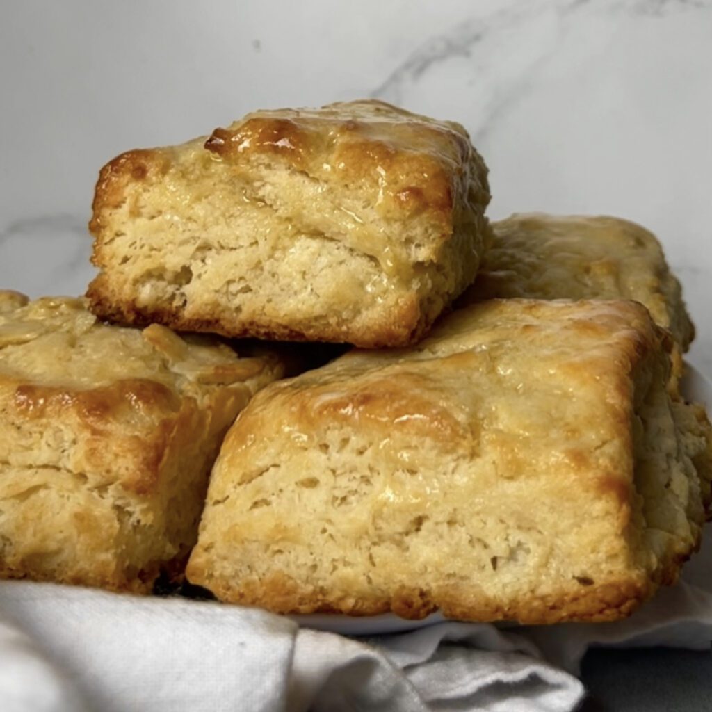 buttermilk biscuits on a plate with white towel