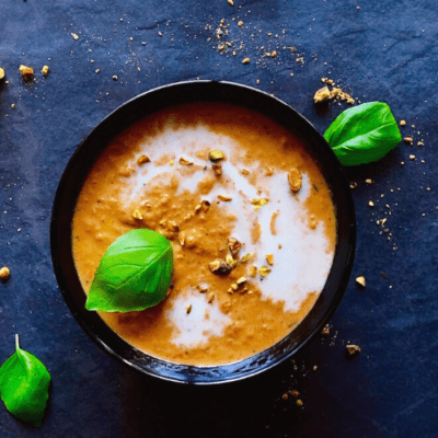 Thai carrot soup garnished with basil overhead