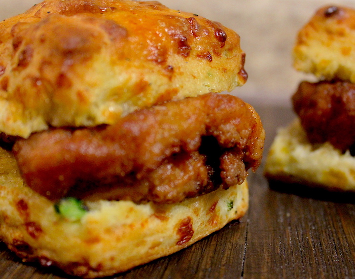 a closeup of two hot honey chicken biscuits