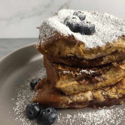 strawberry stuffed french toast with powdered sugar front view