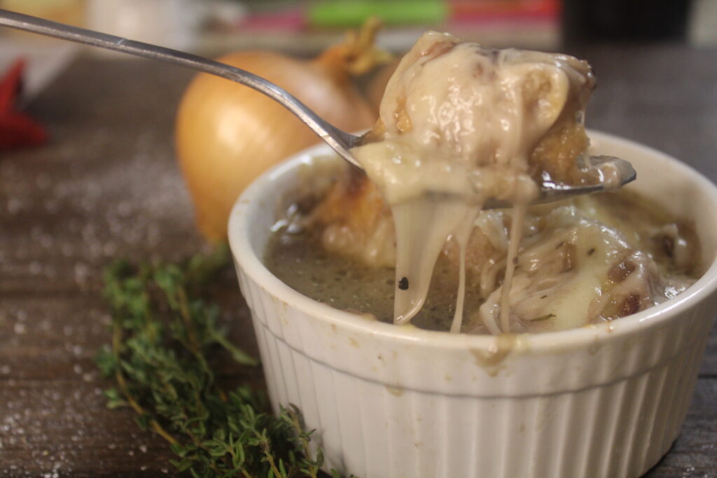 french onion and mushroom soup with cheese pulled