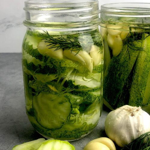two jars of homemade pickles with ingredients