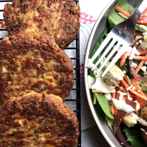 salmon cakes on wire rack with salad on the side