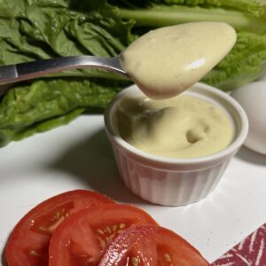 mayonnaise on spoon with lettuce and tomato