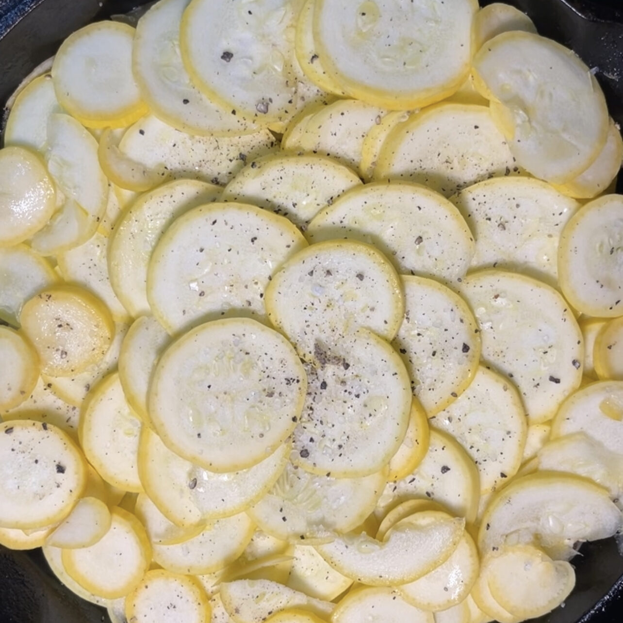 squash and onions in a cast iron pan