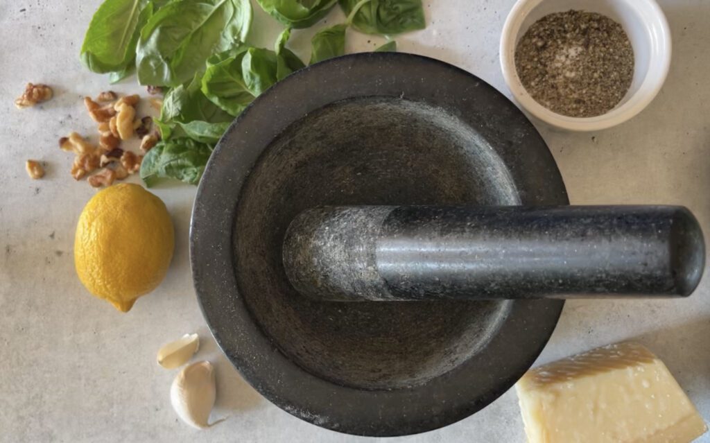 pesto ingredients with mortar and pestle