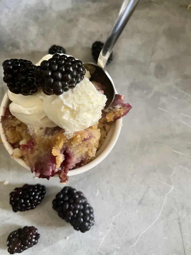 blackberry cobbler with vanilla ice cream and spoon