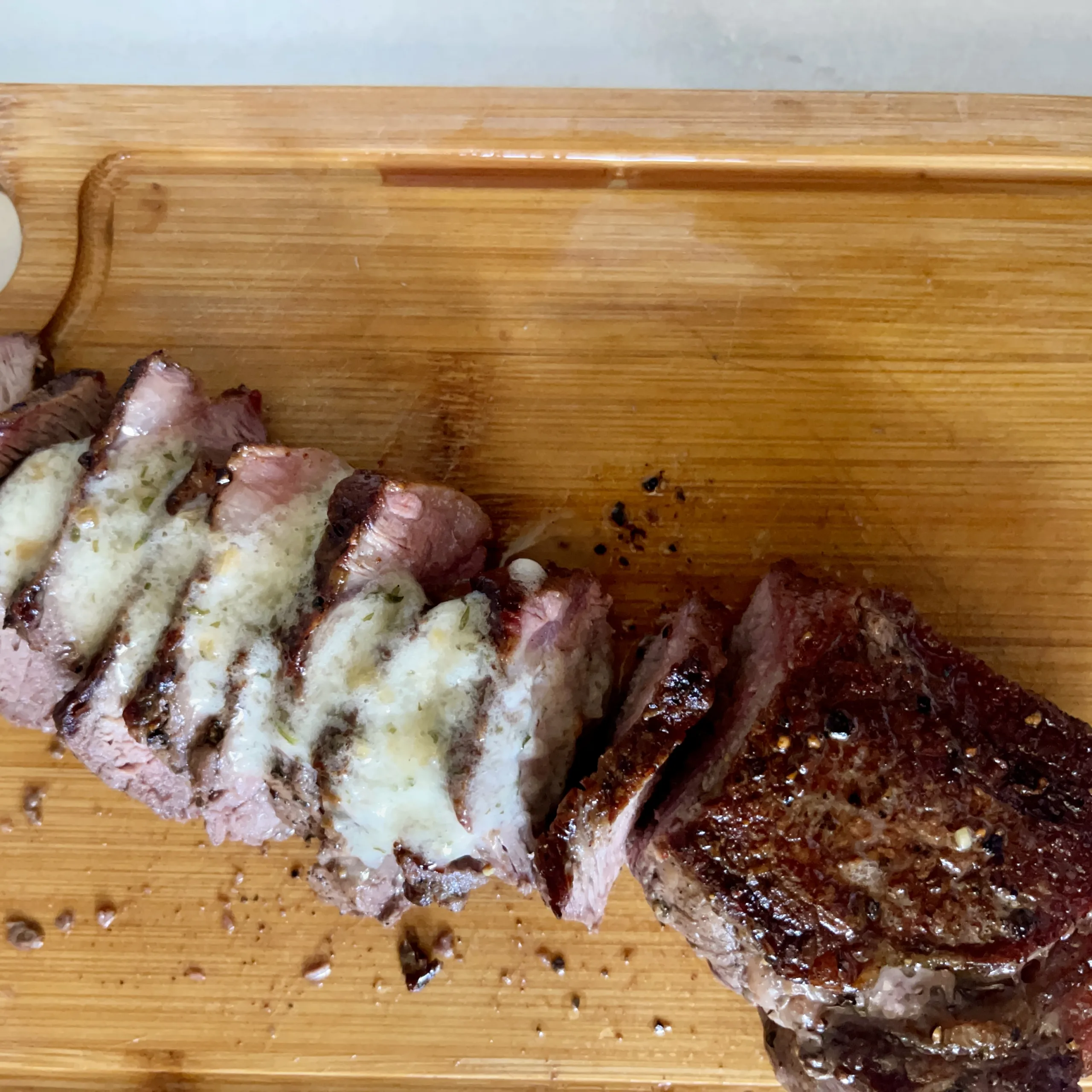 New York strip steak on cutting board