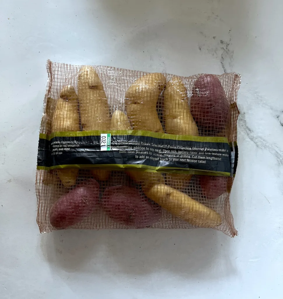the back of the package of fingerling potatoes on white countertop