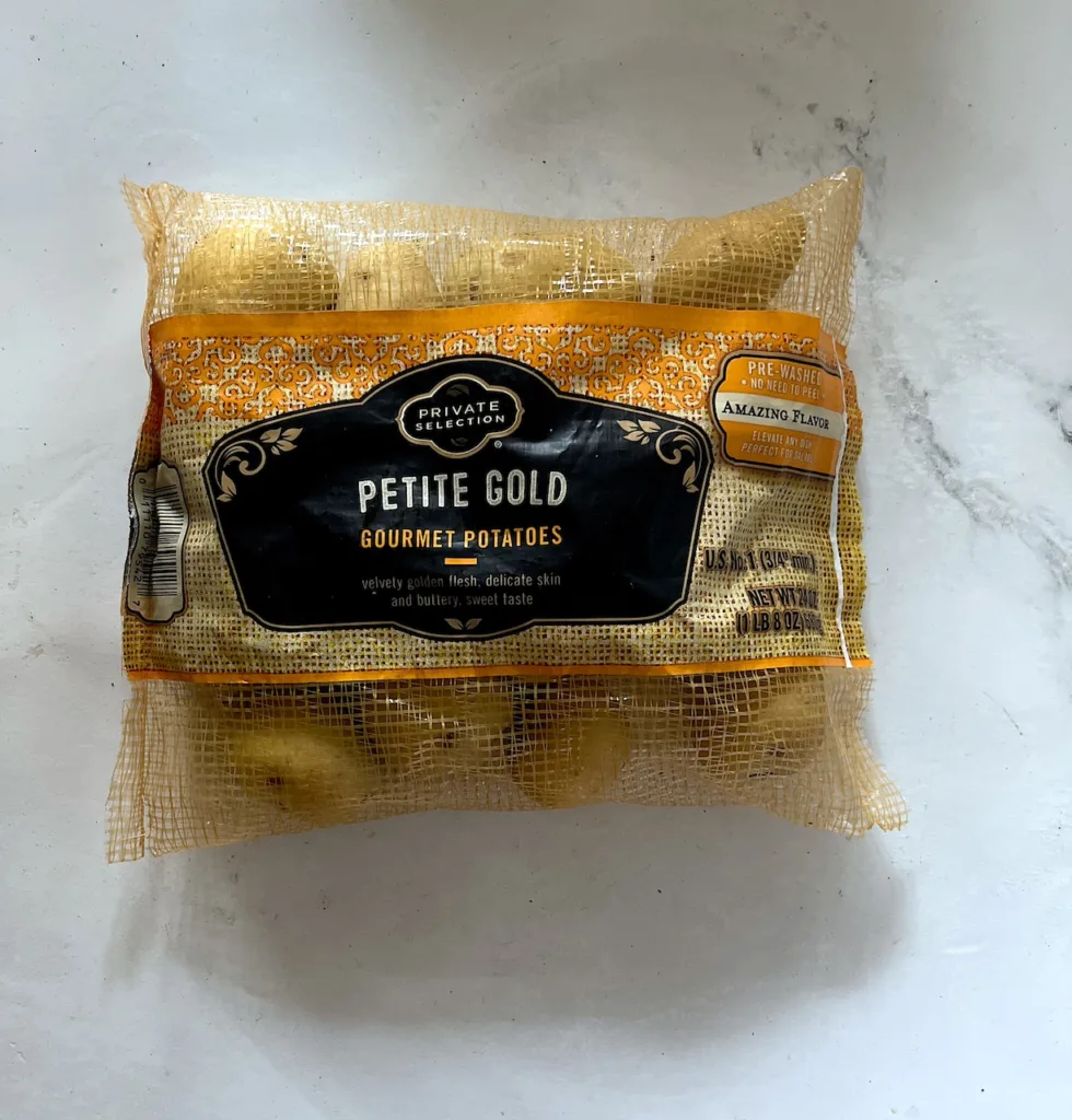 the front of the petite yukon gold potato package on white countertop