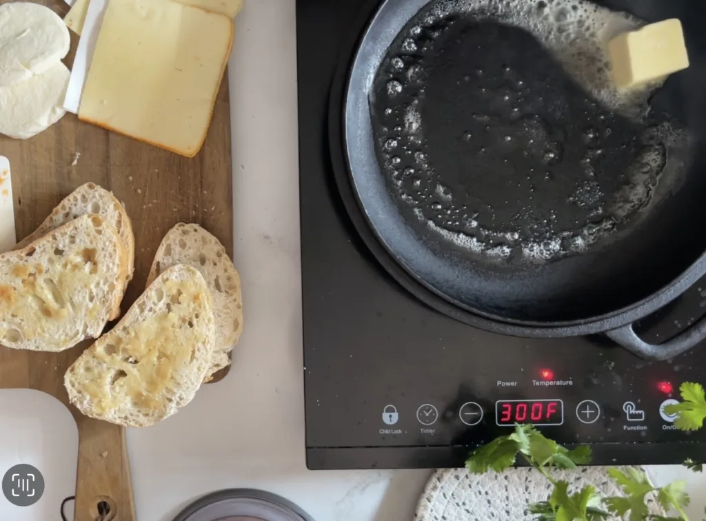 spreading roasted garlic on sourdough bread