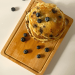 overhead view of blueberry pancakes on a cutting board